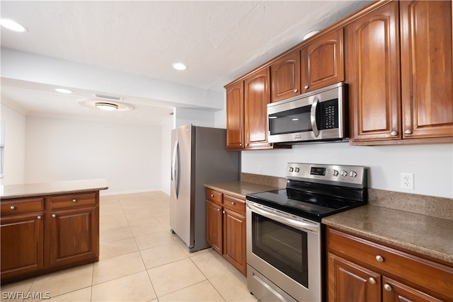 kitchen featuring stainless steel appliances and light tile floors