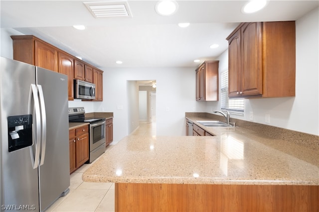 kitchen with light stone countertops, ceiling fan, light tile floors, sink, and appliances with stainless steel finishes