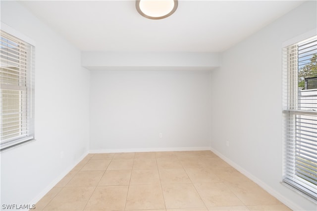 unfurnished room featuring light tile floors