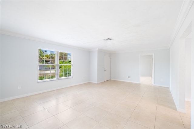 spare room with crown molding and light tile flooring