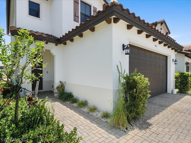 view of side of home featuring a garage