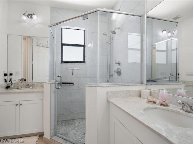 bathroom with an enclosed shower and vanity