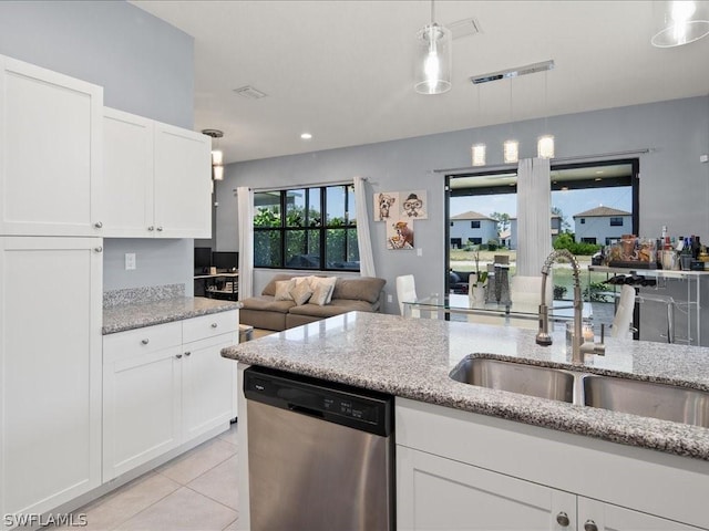 kitchen featuring decorative light fixtures, dishwasher, sink, white cabinets, and light stone counters