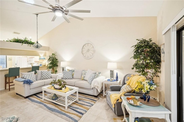 tiled living room with high vaulted ceiling and ceiling fan