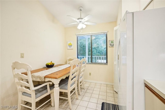 tiled dining area featuring ceiling fan