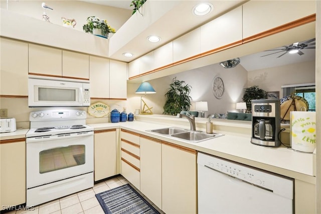 kitchen with white appliances, sink, ceiling fan, light tile patterned floors, and kitchen peninsula