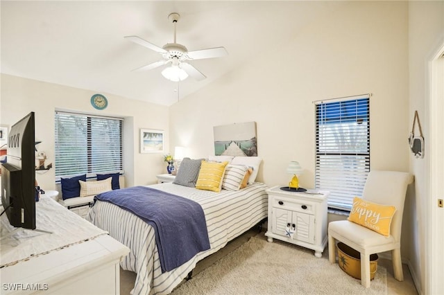 carpeted bedroom featuring ceiling fan and vaulted ceiling