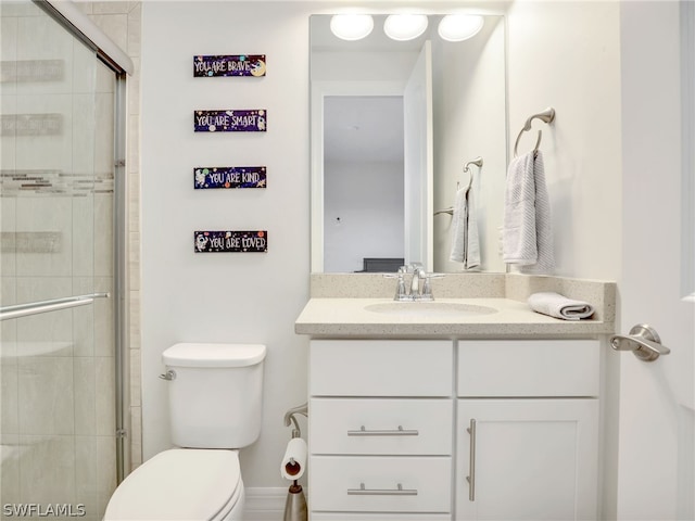 bathroom featuring an enclosed shower, toilet, and vanity