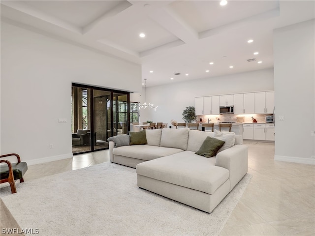 living room with coffered ceiling, a towering ceiling, beamed ceiling, and light tile floors