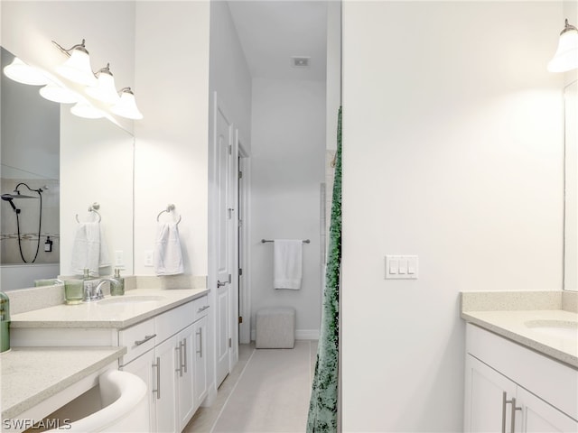 bathroom featuring tile flooring and vanity