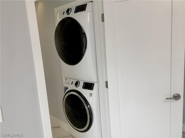 laundry room featuring stacked washer / drying machine