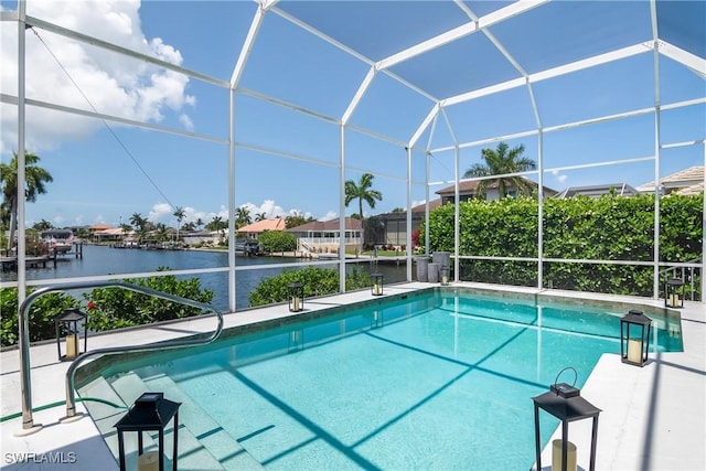 outdoor pool with a lanai and a water view