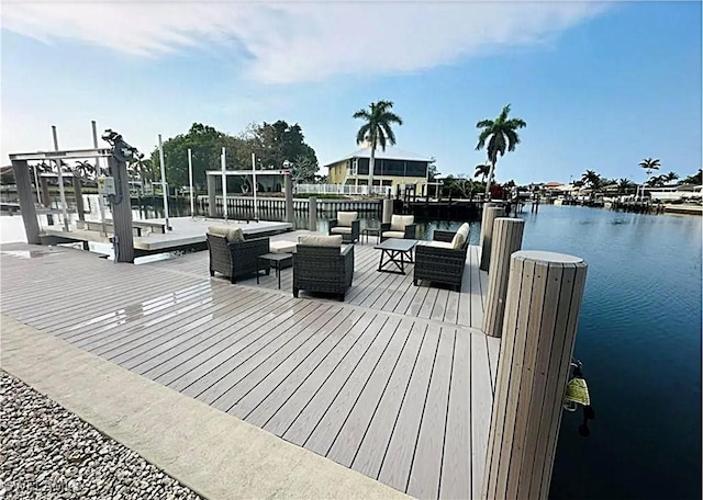 view of dock with a water view and outdoor lounge area