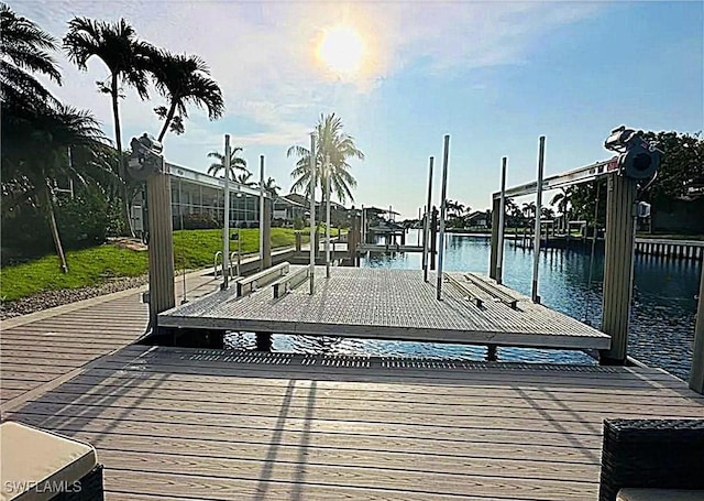 dock area with a water view and boat lift