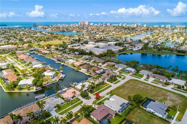 birds eye view of property featuring a water view and a residential view