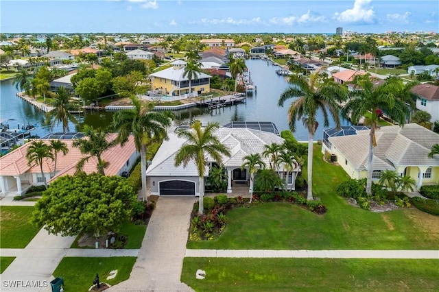 birds eye view of property with a water view and a residential view