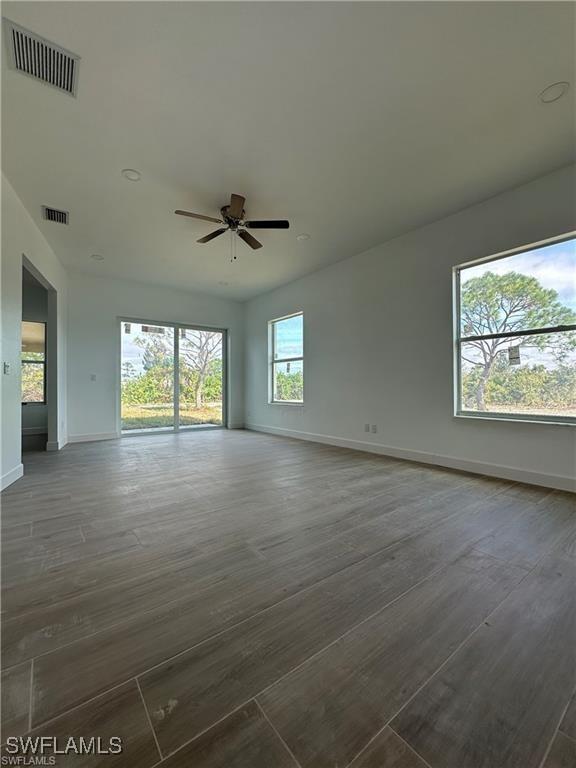 spare room with ceiling fan and dark wood-type flooring