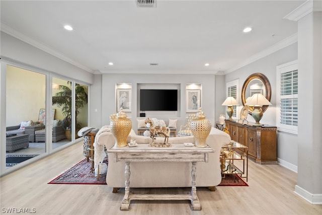 living room with light hardwood / wood-style floors and crown molding