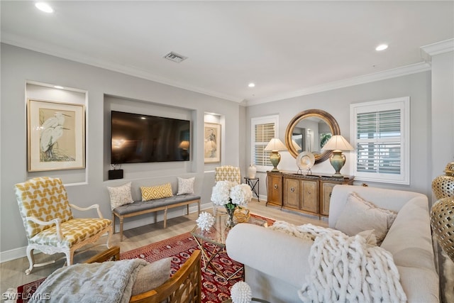 living room with ornamental molding and light hardwood / wood-style floors