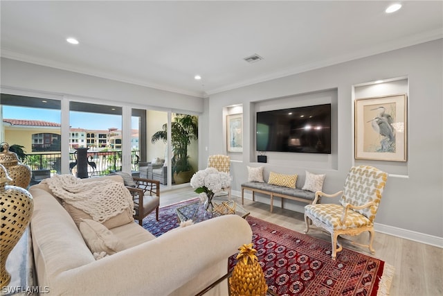 living room featuring ornamental molding and hardwood / wood-style flooring