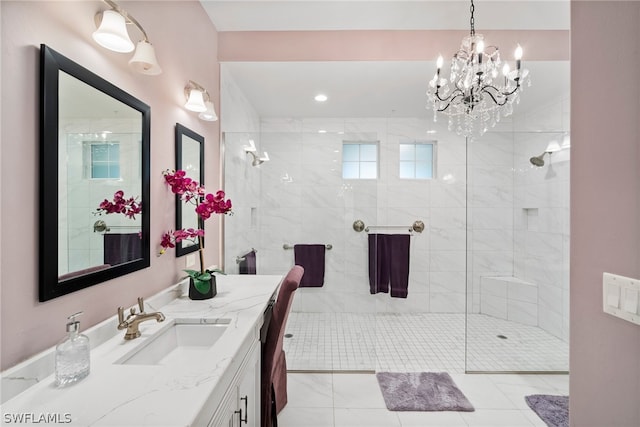 bathroom featuring vanity, tiled shower, a chandelier, and tile flooring