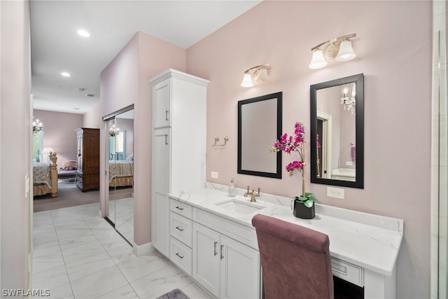 bathroom featuring vanity, tile floors, and a chandelier