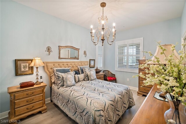 bedroom featuring hardwood / wood-style floors and a notable chandelier