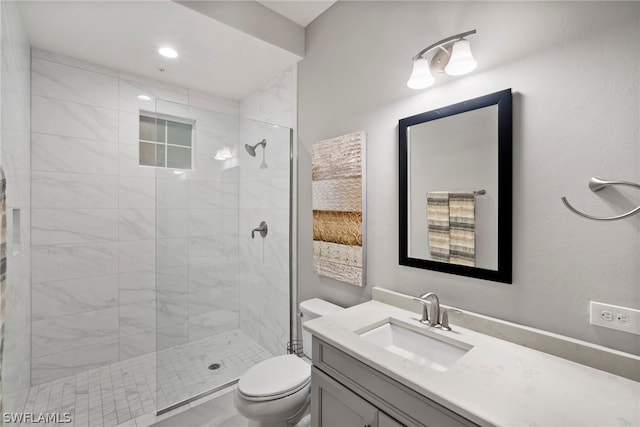 bathroom with vanity with extensive cabinet space, an enclosed shower, and toilet