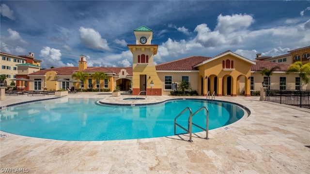 view of swimming pool featuring a patio and a community hot tub