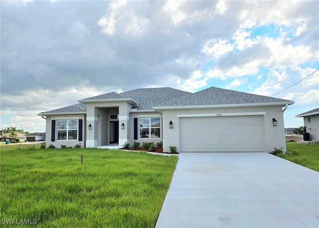 view of front of house featuring a front yard and a garage