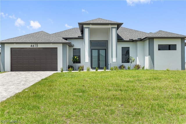 prairie-style house featuring a garage and a front lawn