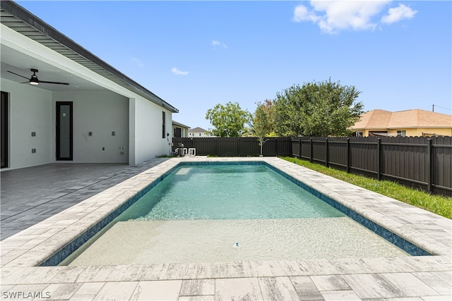 view of swimming pool with ceiling fan and a patio