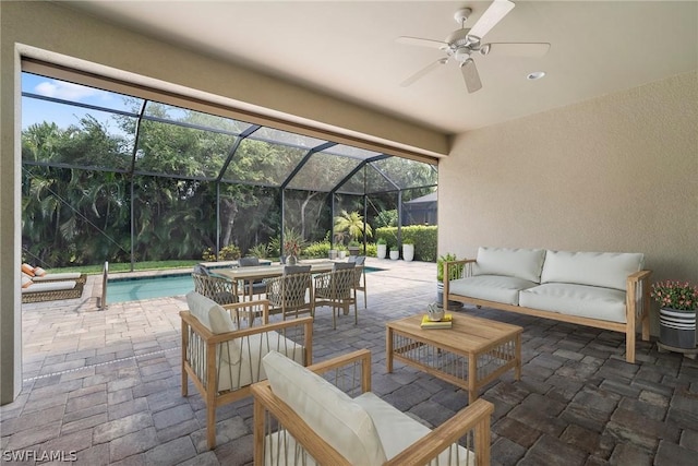 view of patio with ceiling fan, a lanai, an outdoor living space, and an outdoor pool