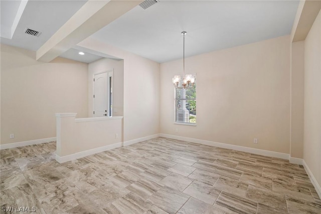 spare room featuring visible vents, a notable chandelier, and baseboards