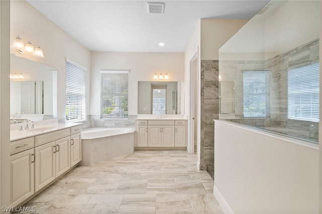 bathroom with two vanities, a sink, visible vents, a bath, and walk in shower