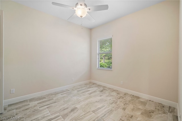 unfurnished room with ceiling fan and baseboards