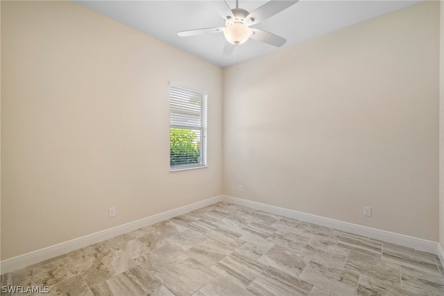 empty room with baseboards and a ceiling fan