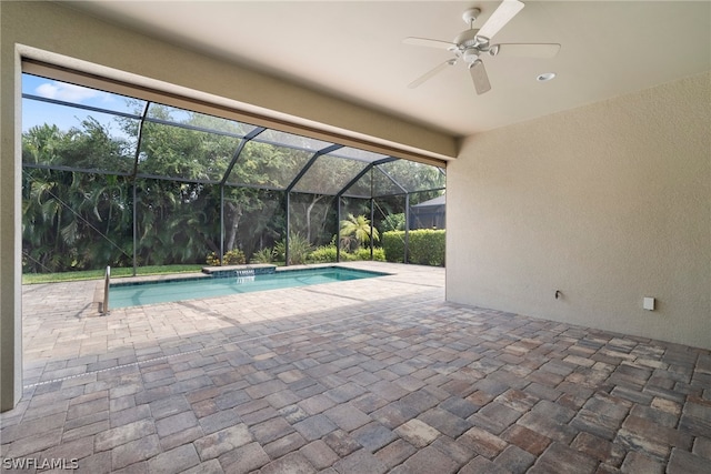 outdoor pool featuring a lanai, a patio area, and ceiling fan