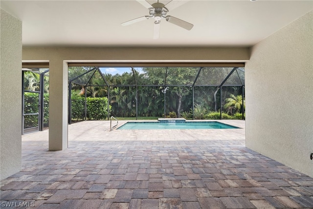 pool with a patio area, ceiling fan, and glass enclosure