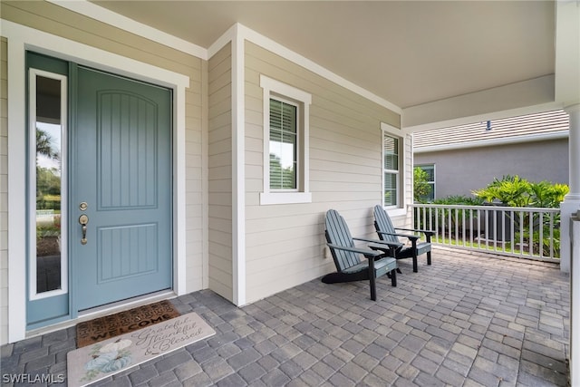 view of exterior entry with covered porch