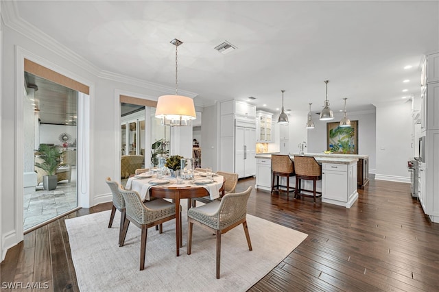 dining room featuring dark hardwood / wood-style floors and crown molding