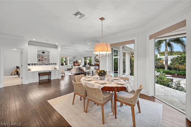 dining area with crown molding and dark wood-type flooring