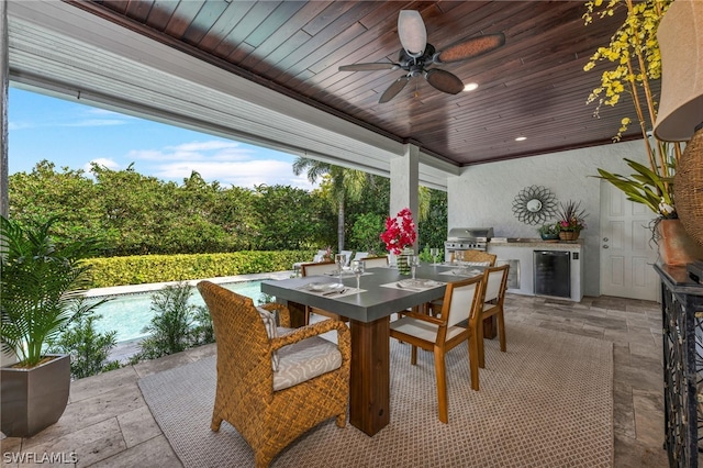 view of patio featuring area for grilling, ceiling fan, and an outdoor kitchen