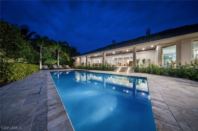 pool at night with a patio