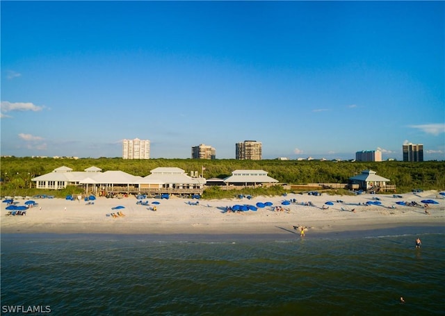 bird's eye view featuring a water view and a beach view