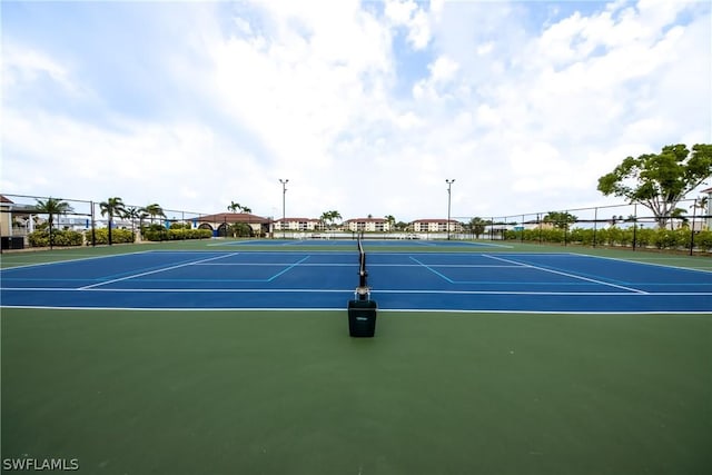 view of tennis court with fence