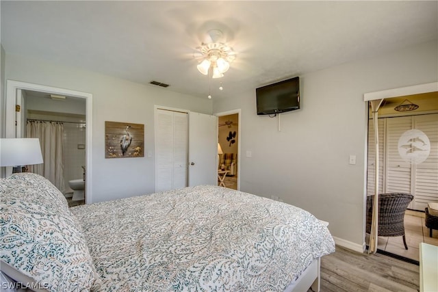 bedroom with ensuite bathroom, a ceiling fan, visible vents, baseboards, and light wood finished floors