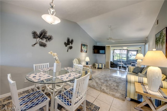 dining area with light tile patterned floors, visible vents, ceiling fan, vaulted ceiling, and baseboards