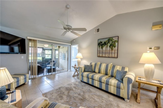 living area featuring a ceiling fan, lofted ceiling, visible vents, and tile patterned floors