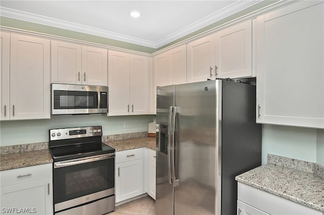 kitchen featuring light stone countertops, white cabinetry, crown molding, and appliances with stainless steel finishes